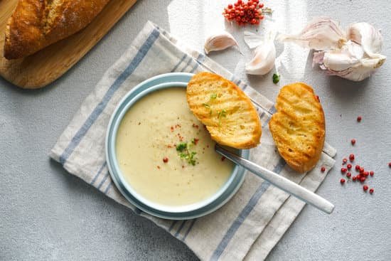canva creamy garlic soup and bread in a bowl MAD mLfULRg