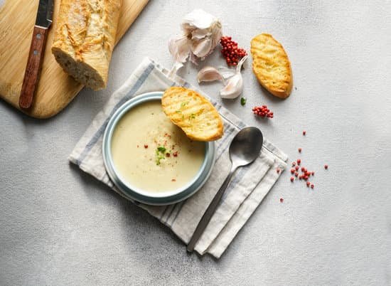 canva creamy garlic soup and bread on a table MAD mJUFnv8