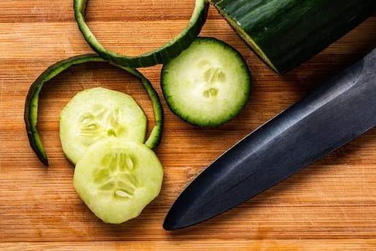 canva cucumber sliced on wooden cutting board MAEL2bxd1 M