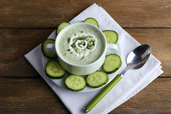 canva cucumber soup in bowl on rustic wooden table MAD MGZRW2s