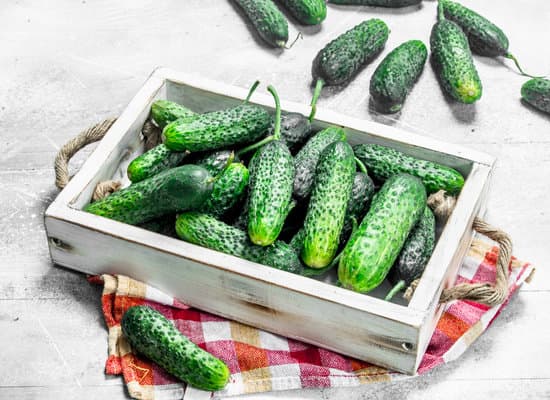 canva cucumbers in a wooden tray with napkin MAEPcwNDXVI