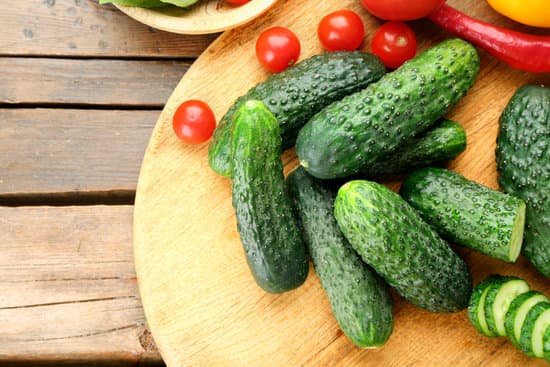 canva cucumbers tomatoes and peppers on wooden background MAD MpkDLRc