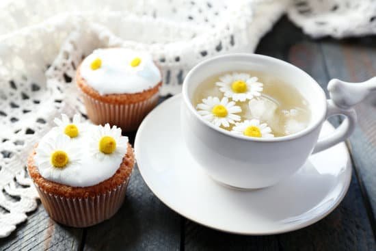 canva cup of chamomile tea with flowers and muffins MAD MbnnN1E