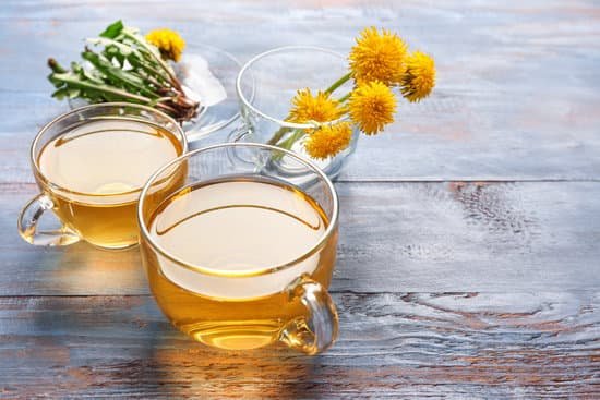 canva cups of healthy dandelion tea and flowers on wooden background MAD7FWHgP14