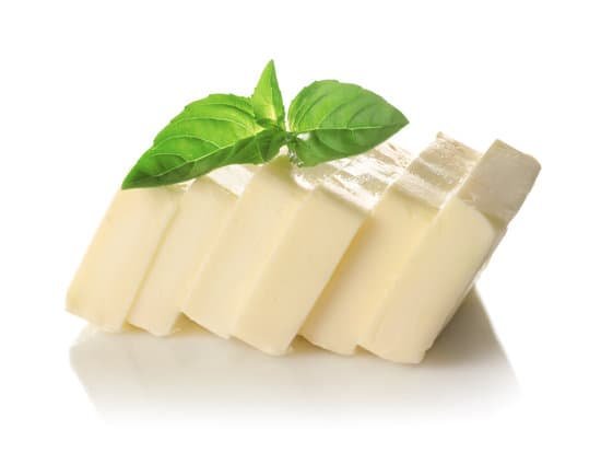 canva cut block of butter with fresh basil leaves isolated on white MAD9bghRrIo