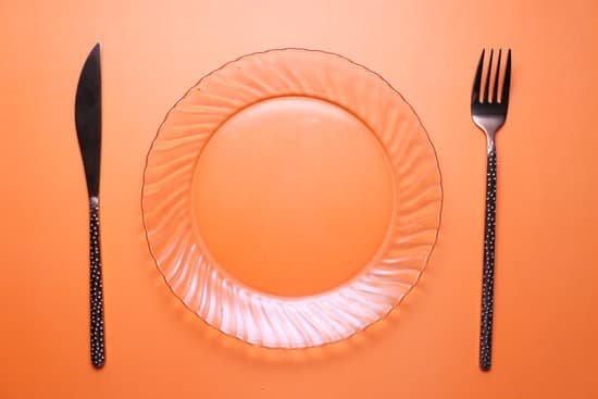 canva cutlery and empty plate on orange background top down MAEEc0GzzvE