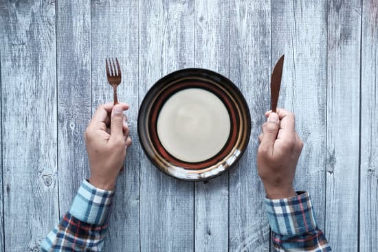 canva cutlery and empty plate on wooden background top down MAEUtQzTOzQ