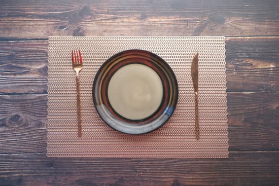 canva cutlery and empty plate on wooden background top down