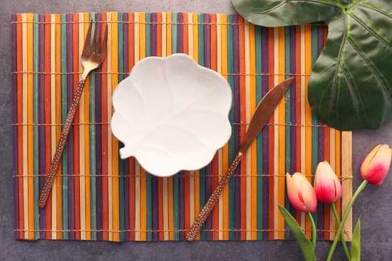 canva cutlery and empty plate on wooden background top down MAEdm agJoU
