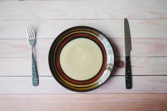 canva cutlery and empty plate on wooden background top down MAEh2Htuddg