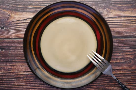 canva cutlery and empty plate on wooden background top down MAEjs y7S6Y