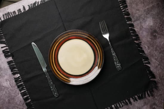 canva cutlery and empty plate on wooden background top down MAEl801lhyg