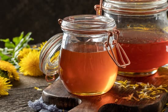 canva dandelion honey in glass jars with fresh dandelions