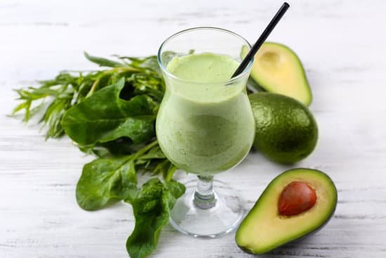 canva delicious fresh avocado smoothie with leaves on white wooden table MAD Qu7NeoI