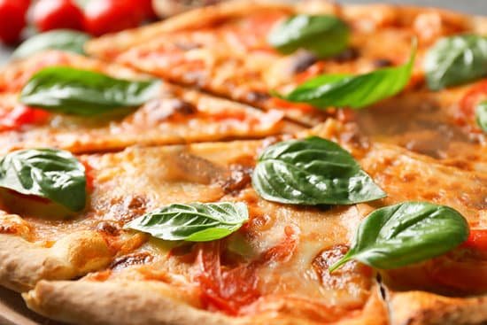 canva delicious pizza with fresh basil closeup MAD9T8f0JpQ