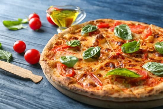 canva delicious pizza with tomatoes and fresh basil close up MAD9T ruJq0