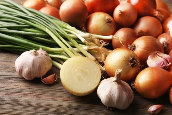 canva different onions with garlic on wooden background MAD M2UGnA0