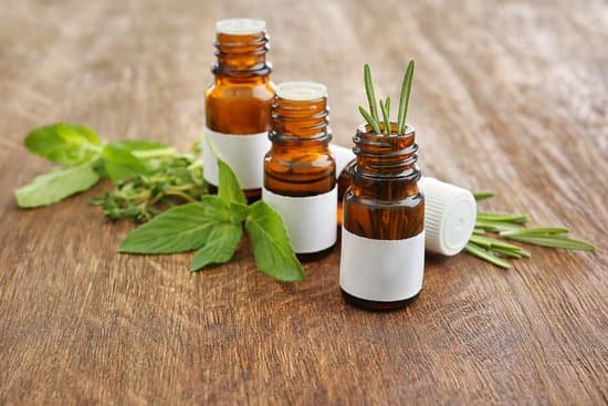 canva dropper bottles and herbs on wooden background MAD Qy h h0