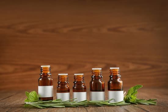canva dropper bottles and herbs on wooden table MAD Q7HbC Q