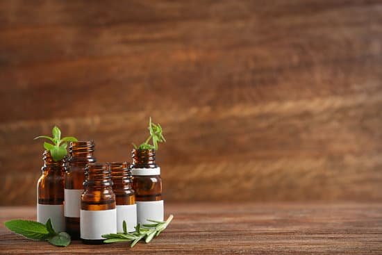 canva dropper bottles and herbs on wooden table MAD QzQcWXE