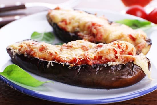 canva eggplant with cherry tomatoes and cheese on a plate MAD MWc1Fk0