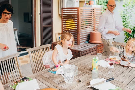 canva family with female children outdoor sitting table having breakfa MAEB7nZtaDs