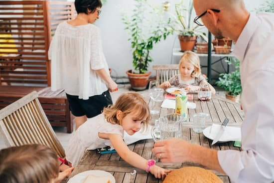 canva family with female children outdoor sitting table having breakfa MAEB7q8LqnE
