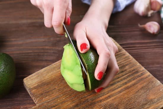 canva female hands cutting an avocado in half MAD Ql3Ta38
