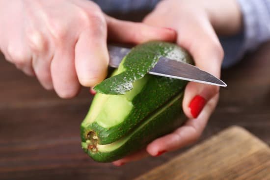 canva female hands peeling an avocado MAD QtVjDsw