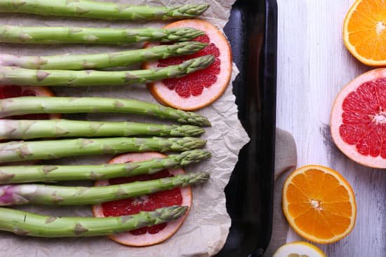 canva fresh asparagus and citrus fruits on a pan MAD MTCfk7w