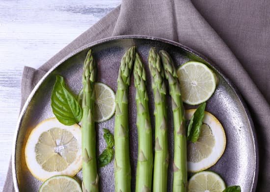 canva fresh asparagus and lemon on a pan MAD MZYfgHc