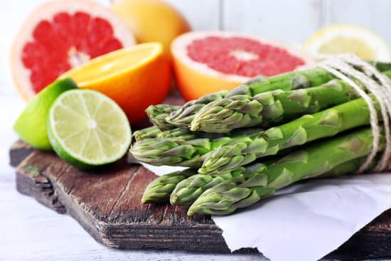 canva fresh asparagus and slices of citrus on cutting board MAD Mcij5Wk