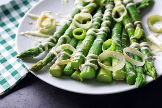 canva fresh asparagus dish with sliced onion on white plate MAD Mm Mu34