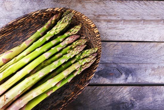 canva fresh asparagus on wooden background MAD MbQDyak