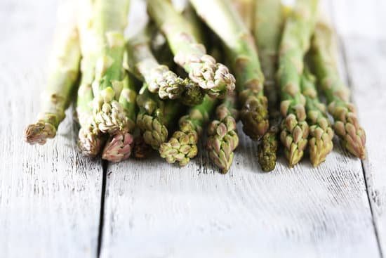 canva fresh asparagus on wooden table closeup MAD