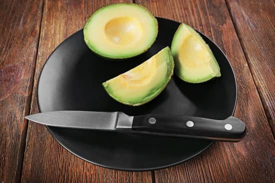 canva fresh avocado on plate with knife MAD Qq85V1s