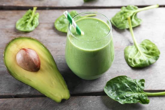 canva fresh avocado smoothie on wooden background MAD QqhsfC4