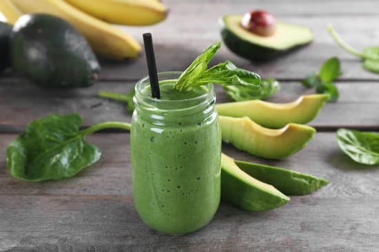 canva fresh avocado smoothie with slices on wooden background MAD QgLbMfM