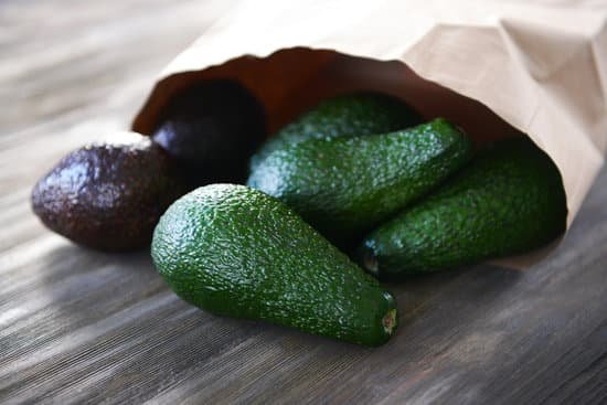 canva fresh avocados in paper bag on wooden background MAD QvyWueE