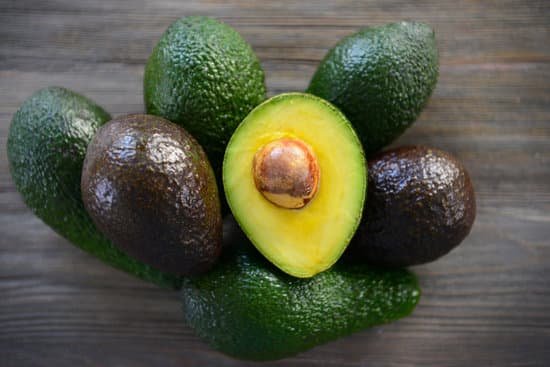 canva fresh avocados on wooden background MAD QqRAMoo