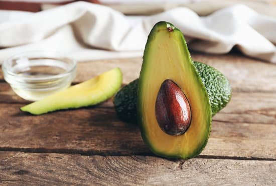 canva fresh avocados on wooden table MAD QpbbFjM