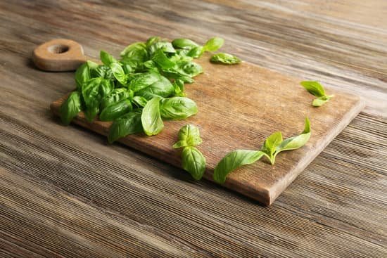 canva fresh basil leaves on wooden board MAD QncAnQc