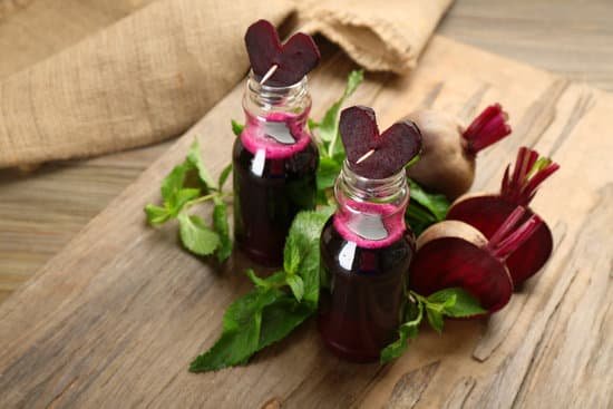 canva fresh beet juice in bottles on wooden table MAD MTZhCdc