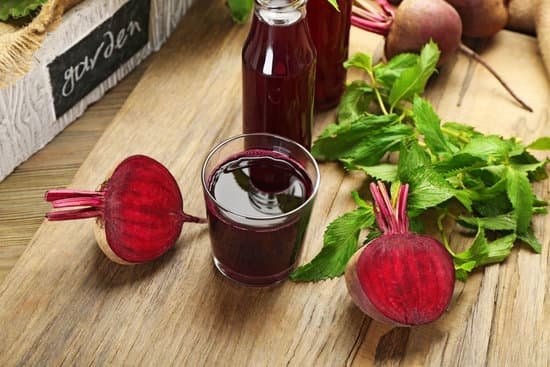 canva fresh beet juice on wooden table close up MAD MR6LlKE