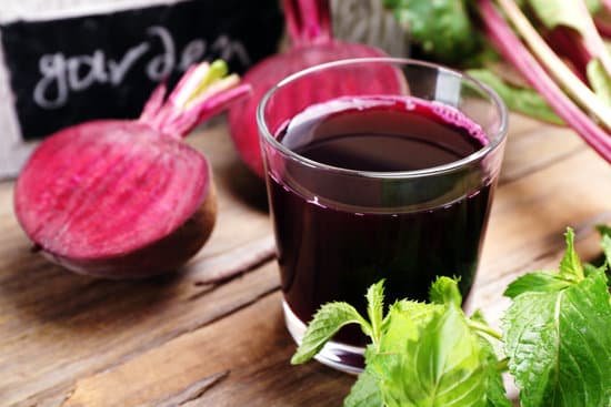 canva fresh beet juice on wooden table closeup MAD MTzIjgg