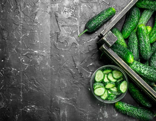 canva fresh cucumbers in a bowl and wooden box copy space