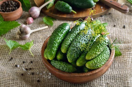 canva fresh cucumbers in a wooden bowl MAEMeRDHAw8