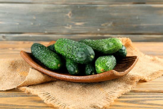 canva fresh cucumbers in rustic plate on wooden background MAD MgcH2Hg