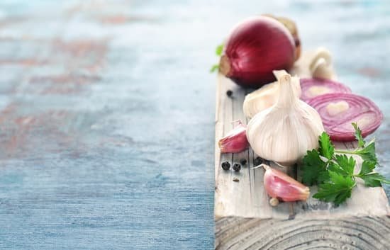 canva fresh garlic and onion on wooden board on table closeup MAD8Sg9PD88