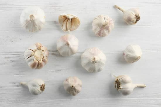 canva fresh garlic on white wooden background MAD76qRG2PI